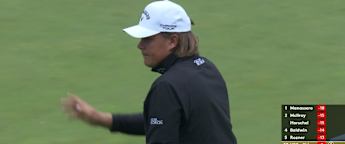 Sami Välimäki holes a long curling putt at the second