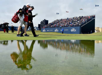 Harrington happy to benefit from bad weather