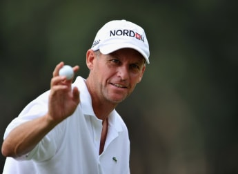 Hansen holds firm to lead in wind-swept Hong Kong