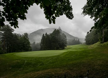 Widing battles through the conditions to lead the way after round three is yet to be concluded