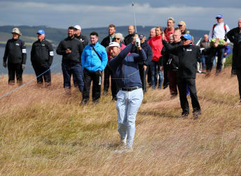 McDowell happy to hang on in windy Scotland