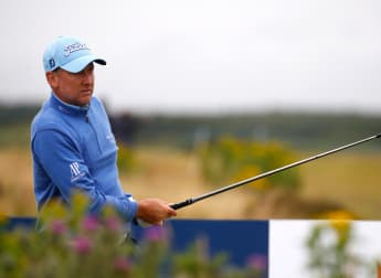 Poulter shares lead at wild and windy Dundonald