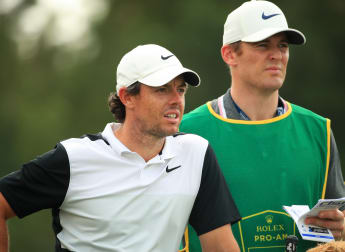 McIlroy calm in caddie's absence