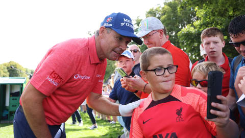 Padraig Harrington of Ireland poses for a photo with a young fan during the Pro-Am