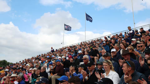 Spectators look on from the 18th Green Grandstand during Day Three