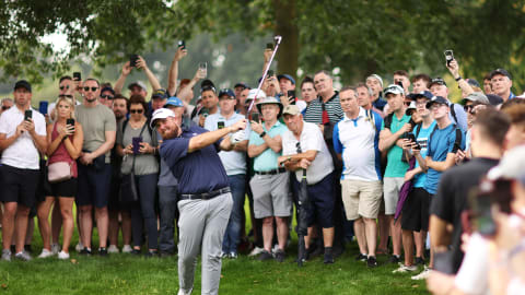Fan favourite Shane Lowry plays his second shot on the ninth hole