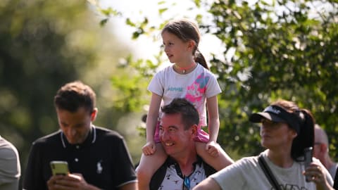 A young golf fan looks on during Day Two