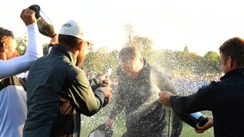 Alex Noren is showered with champagne after his win at the Grove