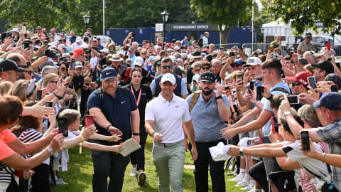 Rory McIlroy makes his way to the first tee ahead of Day Four