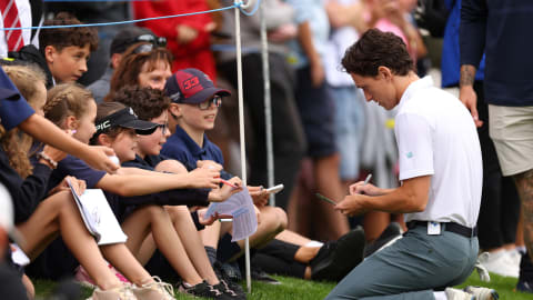 Tom Holland signs autographs following his round during the Pro-Am