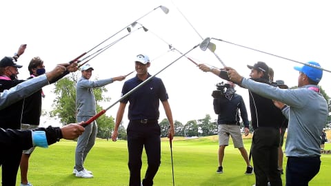 Renato Paratore receives a guard of honour from other players after his win in 2020