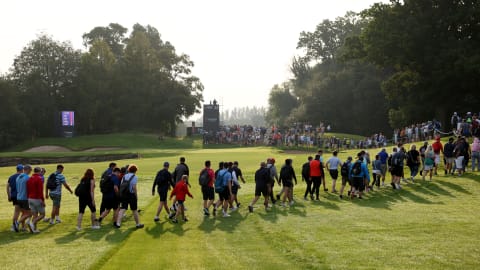 Crowds walk on the 12th hole during Day One