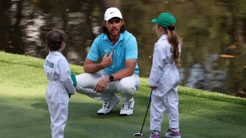 Tommy Fleetwood talks with his son, Franklin, and Lowry's daughter Iris