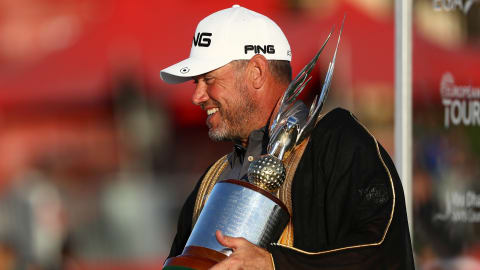 Lee Westwood holds the trophy after winning in Abu Dhabi