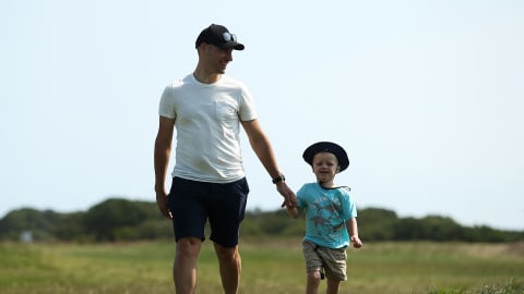 Spectators walk down the fairway at 13th Beach Golf Links 