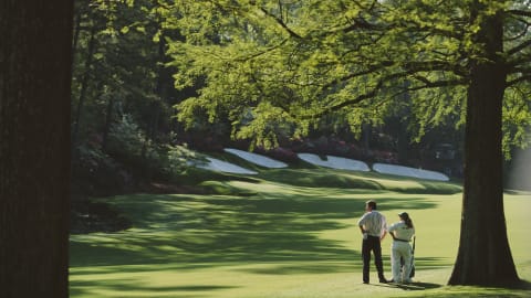 Nick Faldo and caddie Fanny Sunesson take stock before Faldo's two-iron into the heart of the 13th green on his way to his third Green Jacket in 1996 / Credit: David Cannon