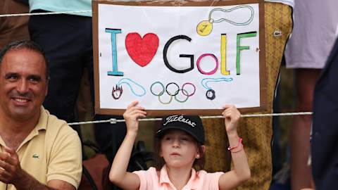 A young fan shows her love for golf's involvement in the Olympic Games