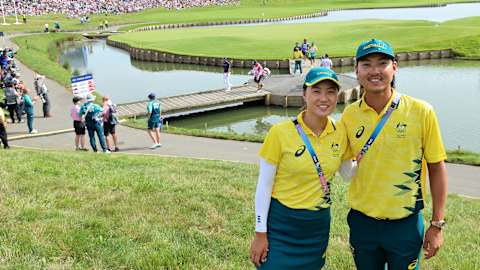Min Woo Lee and his sister Minjee Lee pose for a photograph beside the 18th green