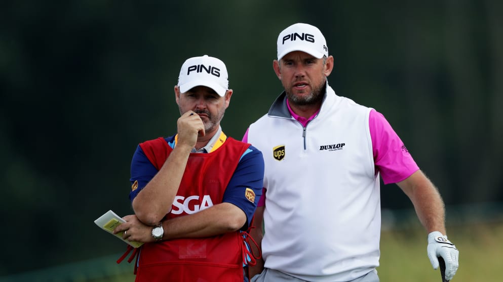 Lee Westwood chats to his caddie Billy Foster during the first round of the US Open at Oakmont Country Club
