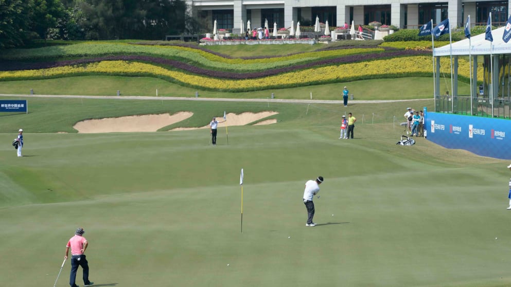 A player putts across the adjoined ninth and 18th greens at The Foshan Open (Richard Castka)