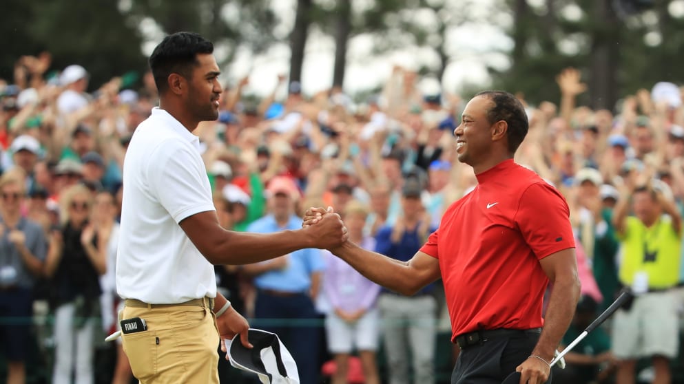 (L-R) Tony Finau congratulates Tiger Woods