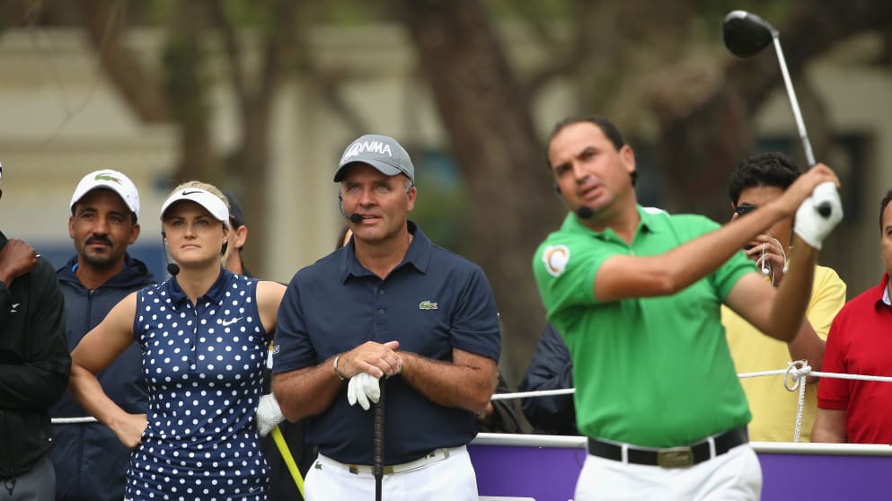 Carly Booth and Thomas Levet look on as Younes El Hassani hits a shot during a mixed exhibition match prior to the start of the Trophee Hassan II 