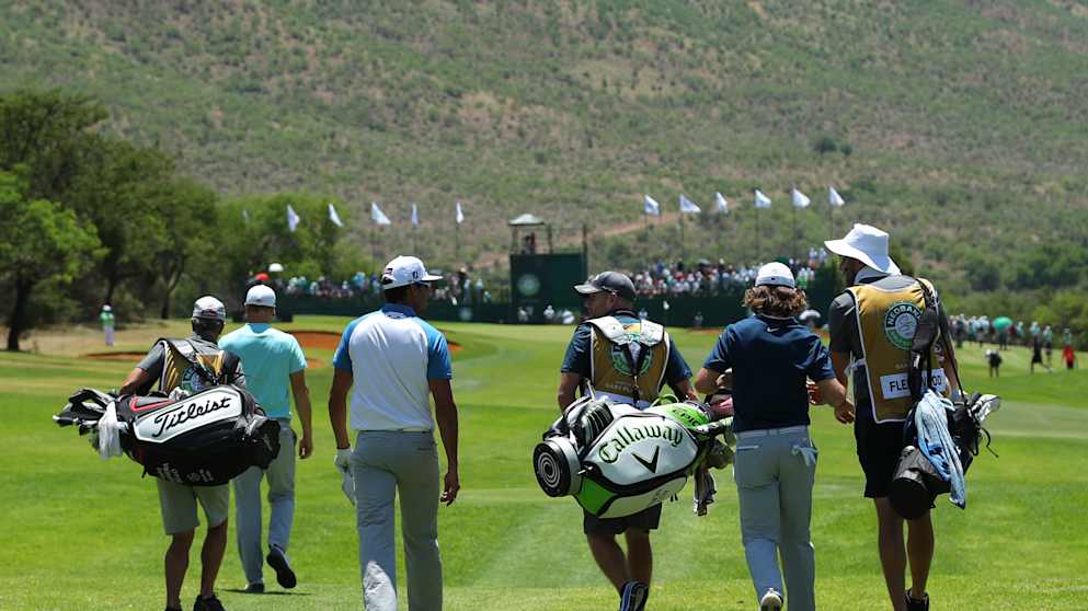 Tommy Fleetwood walks down the 1st hole with Rafa Cabrera-Bello and Alex Noren 