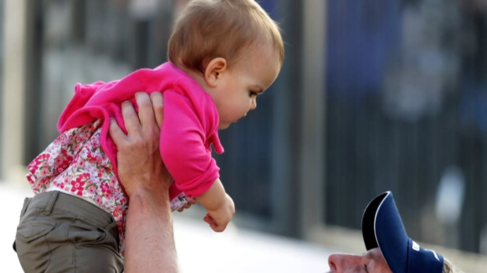 Luke Donald lifts up his daughter Elle after his BMW PGA win