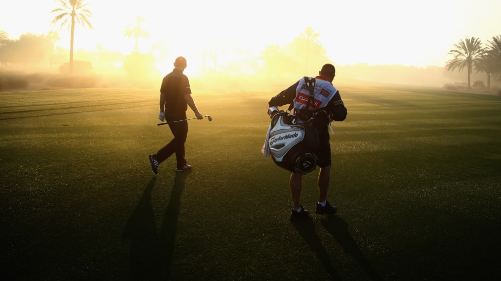 Stephen Gallacher and his caddie Damian Moore walk up the tenth fairway