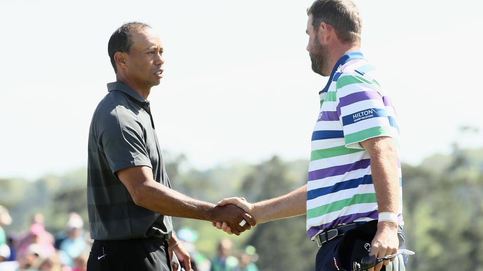 Tiger Woods of the United States shakes hands with Marc Leishman