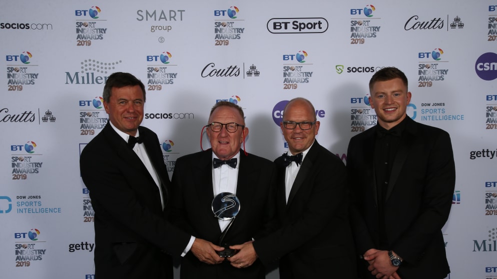 L-R: Edward Kitson, Richard Hills and Guy Kinnings receive the BT Sports Industry Award for Event of the Year from Olympic and World Champion swimmer Adam Peaty