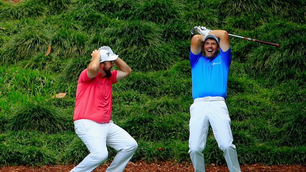 Padraig Harrington and Shane Lowry react after Harrington almost aced the ninth hole during the Masters Tournament's Par 3 Contest