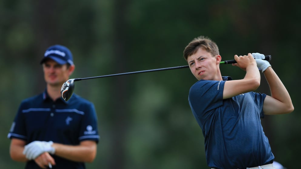 England's Matthew Fitzpatrick hits his tee shot as defending champion and compatriot Justin Rose looks on during the first round of the 114th U.S. Open