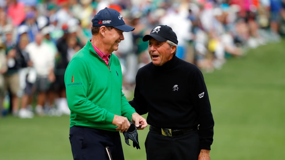 Gary Player celebrates with Tom Watson after making a hole in one on the seventh hole during the Par 3 Contest at the Masters