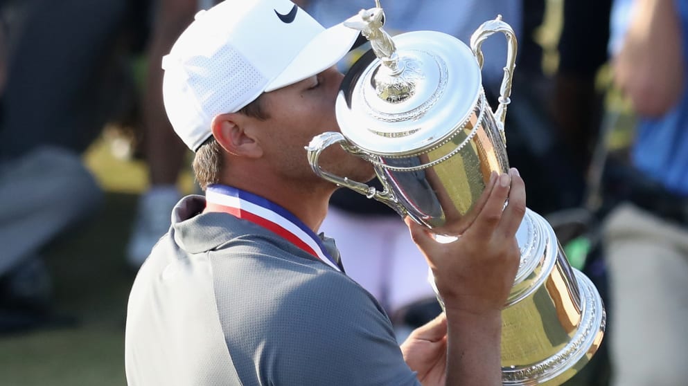 Brooks Koepka lifts the U.S. Open Championship trophy after winning the 2018 U.S. Open at Shinnecock Hills