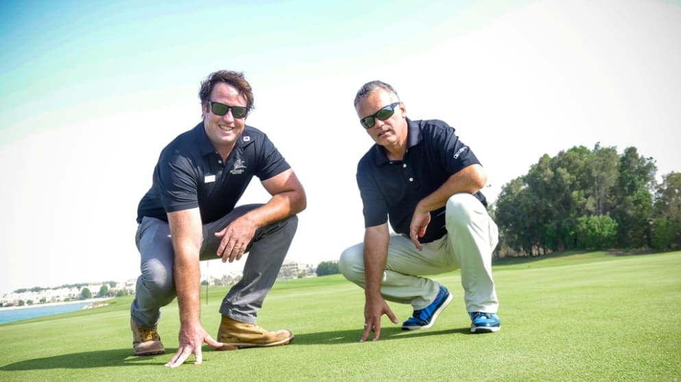 Al Hamra Chief Superintendent Alex McDowell and Deputy Director of Tour Agronomy Graeme MacNiven inspect the turf at Al Hamra Golf Club
