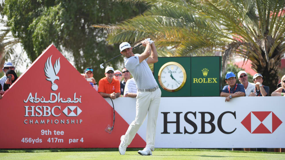 Dustin Johnson tees off at the ninth hole in Abu Dhabi