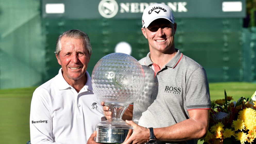 Alex Noren receives the trophy from Gary Player