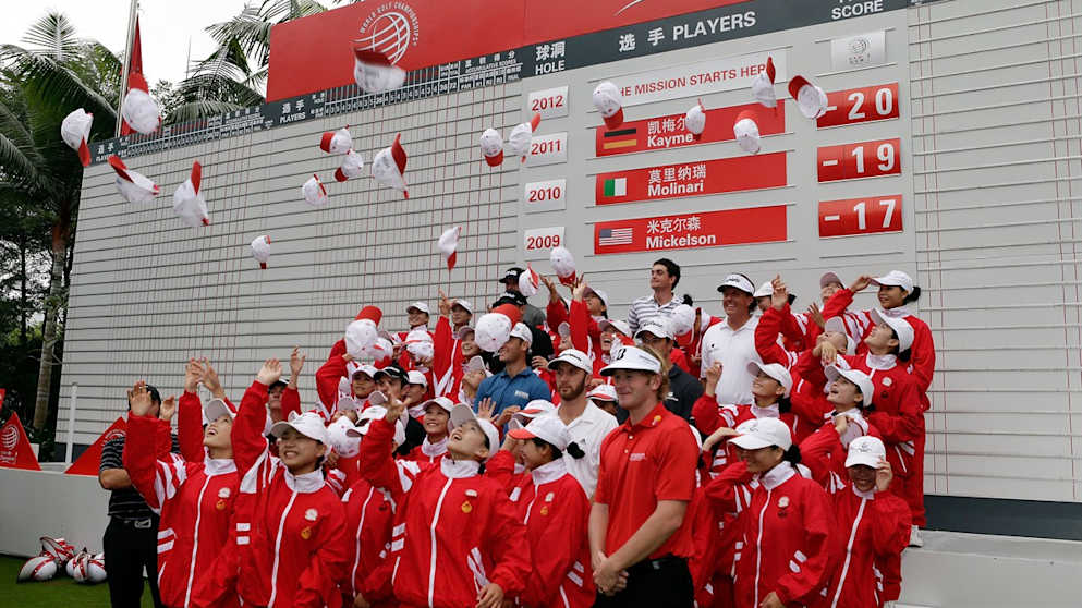 Mission Hills Caddies throw their caps in the air as players look on 