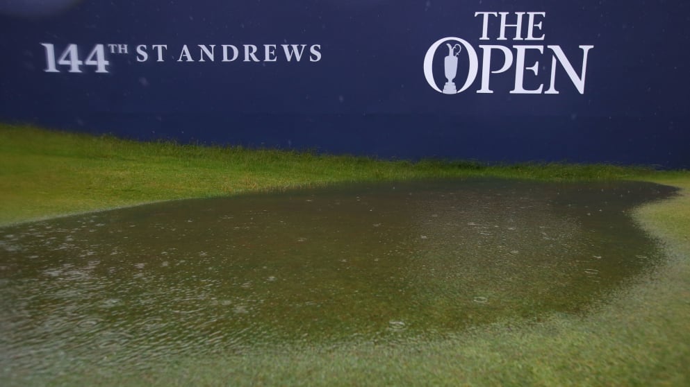 Puddles form on the course as rains falls prior to the second round