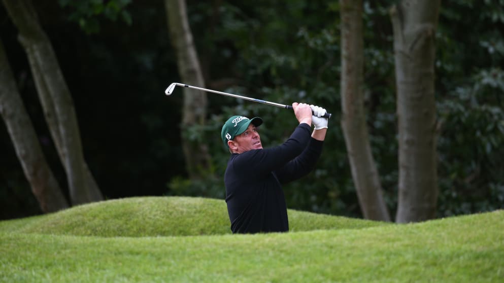 Former Australia cricketer Shane Warne plays from a bunker during the BMW PGA Pro-Am
