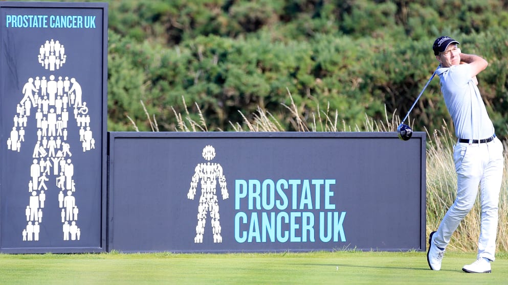 Gary Marks tees off in front of the Prostate Cancer UK boards