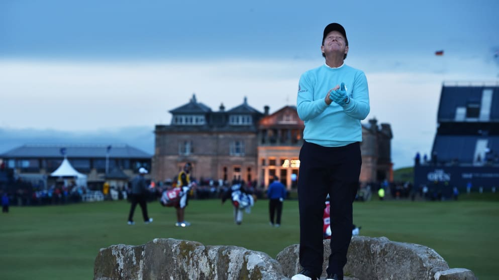 Tom Watson  looks to the sky as he stands on the Swilcan Bridge