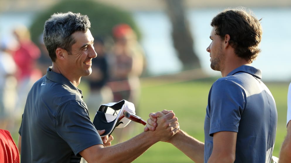 Ross Fisher of England and Thomas Pieters of Belgium shake hands on the 18th green