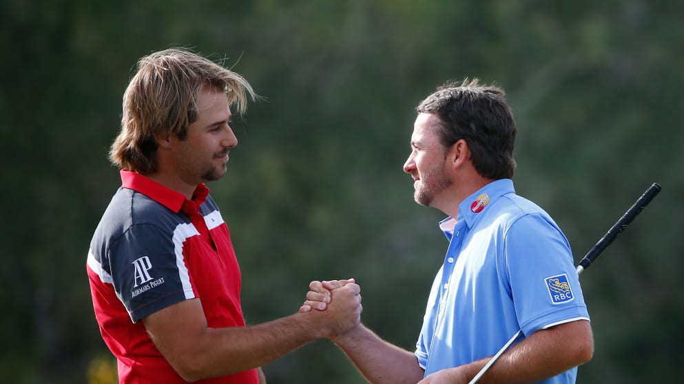 Victor Dubuisson and Graeme McDowell shake hands at the end of a great match