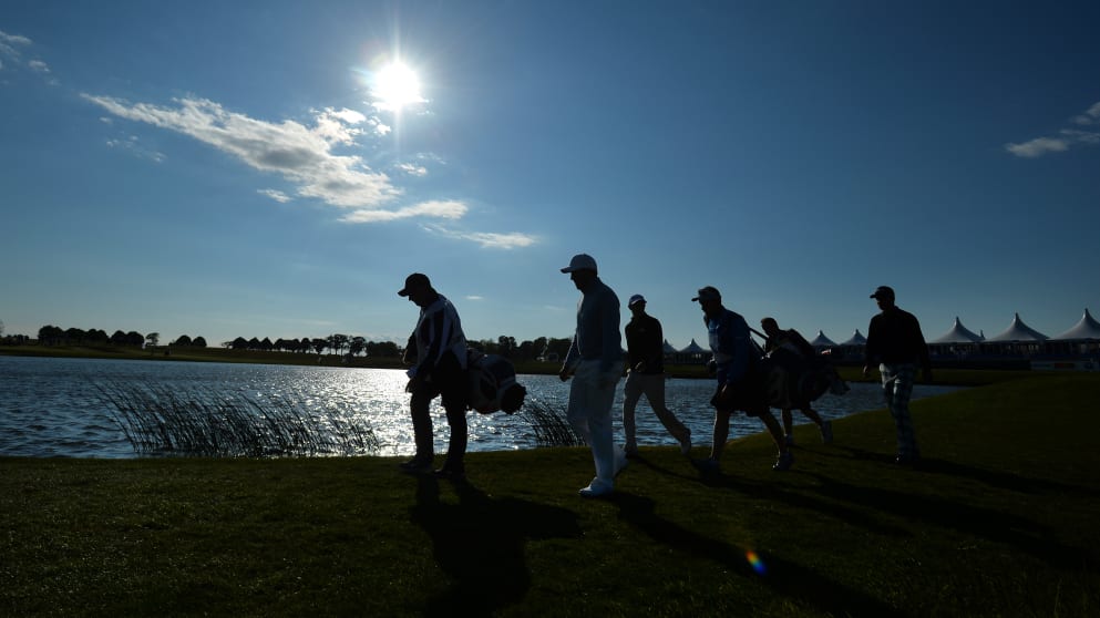 Players walk up the ninth hole at PGA Sweden National
