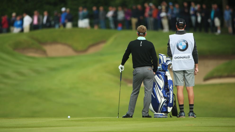 Thinking, thinking. Luke Donald looks on.
