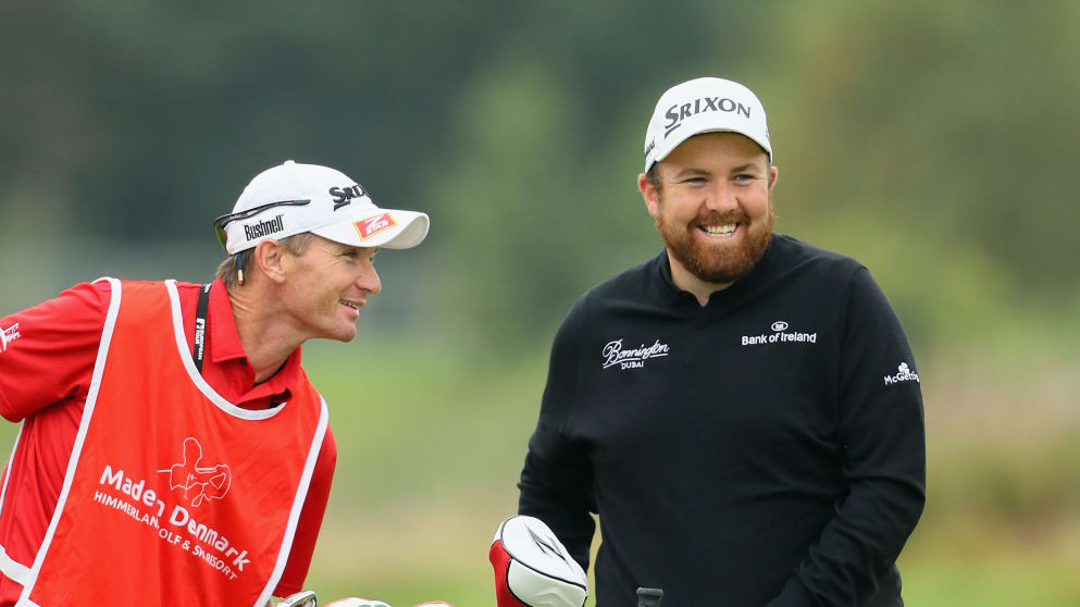 Shane Lowry shares a joke with his caddie Dermot Byrne on the 18th hole 