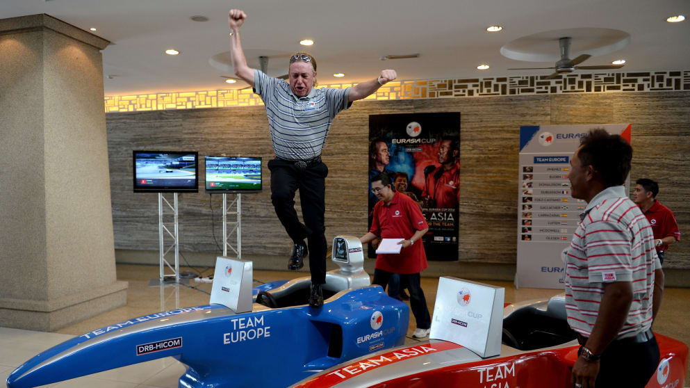 Miguel Angel Jimenez, the Captain of Team Europe and Thongchai Jaidee, Captain of Team Asia take part in an F1 challenge