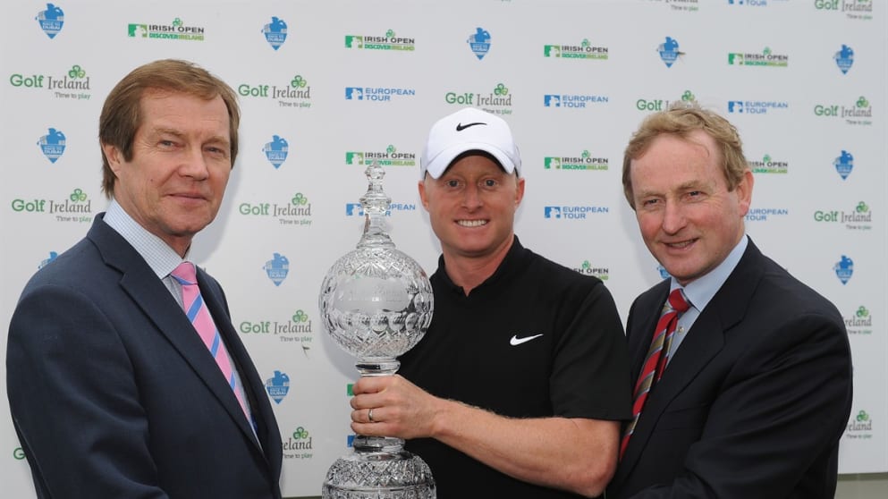 Simon Dyson of England is presented with the winners trophy by Taoiseach Enda Kenny and George O'Grady